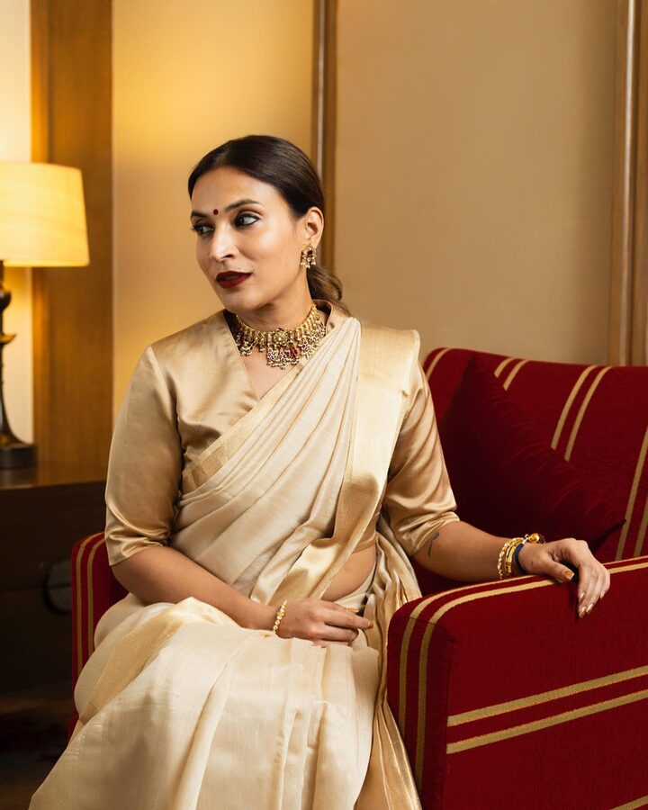 Aishwarya Rajinikanth, Indian film director and playback singer, seated in a cream handloom saree