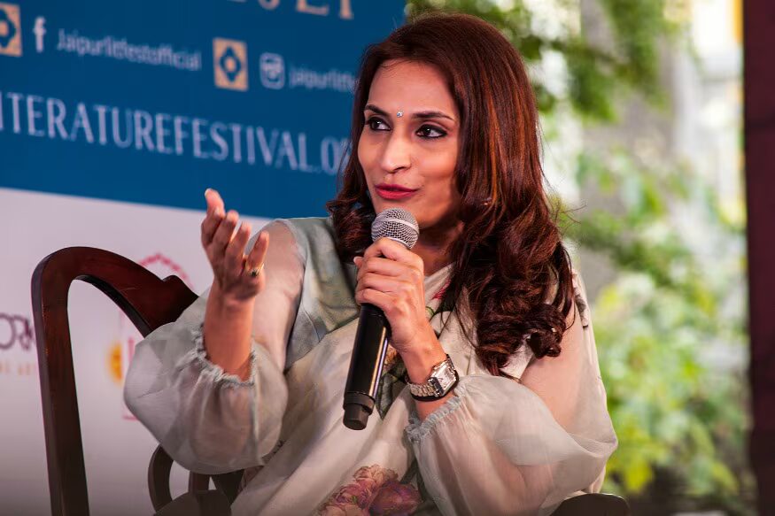Aishwarya Rajinikanth speaking into a microphone on stage at the Jaipur Literature Festival